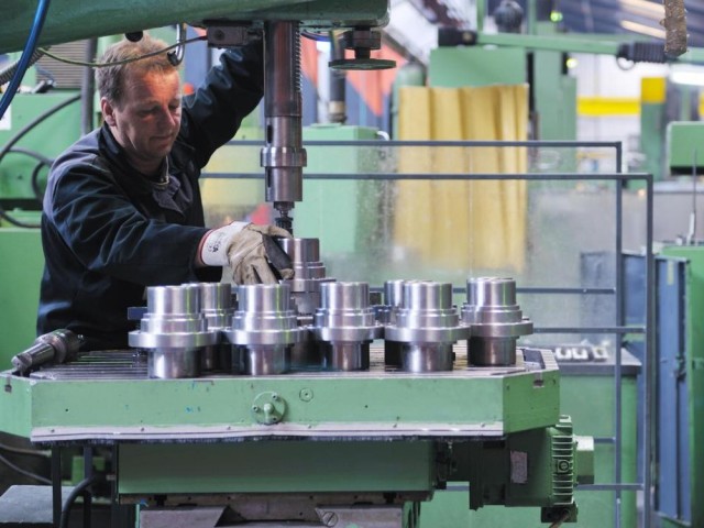 75-2 man-working-on-silver-metal-pieces-in-a-factory (2)
