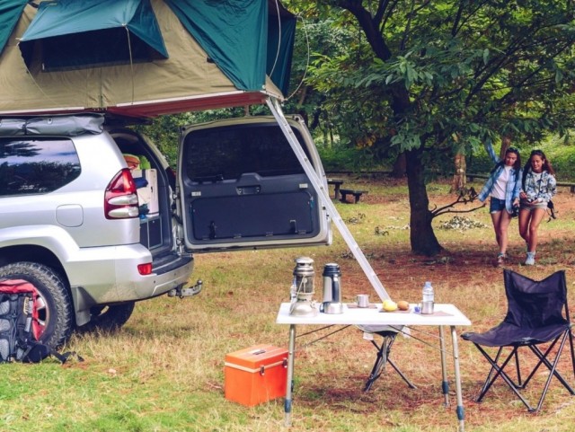Camping table and off road vehicle in campsite