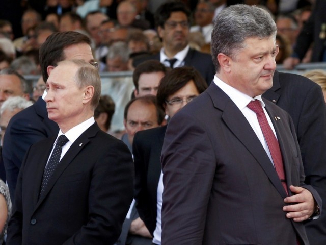 Ukraine's President-elect Petro Poroshenko walks past Russian President Vladimir Putin during the commemoration of the 70th anniversary of the D-Day in Ouistreham
