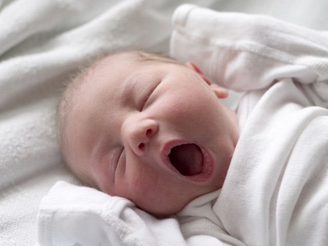 Sleeping baby yawning
