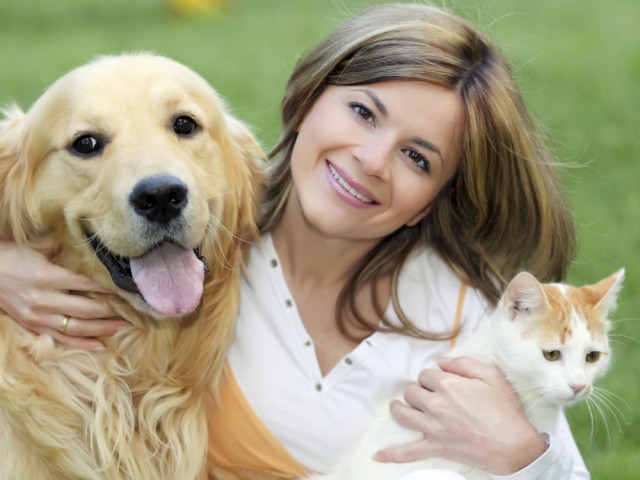 Young woman with dog and cat.