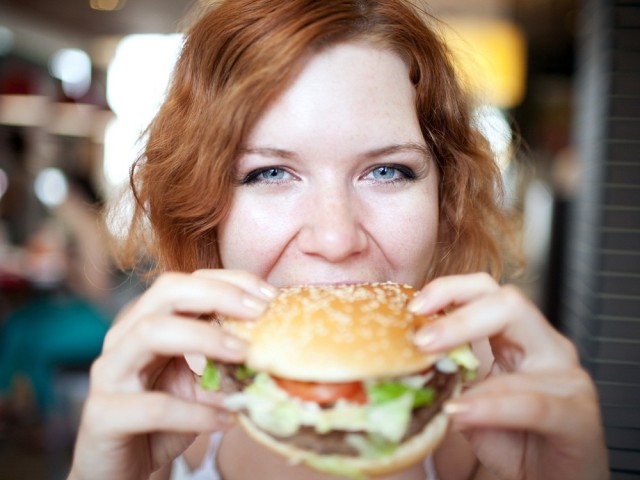 177 woman-eating-hamburger-eat-healthy-while-out (2)