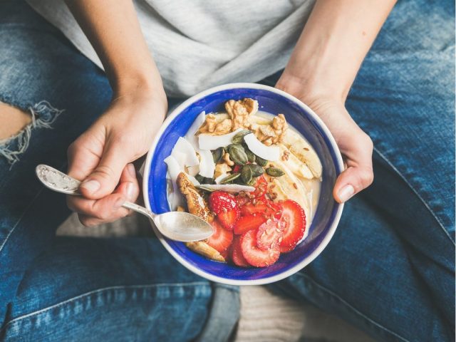 Yogurt, granola, seeds, fresh, dry fruits and honey in bowl
