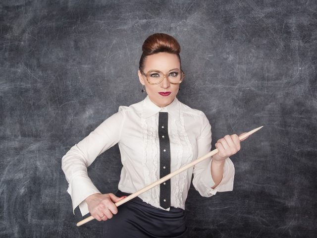Strict teacher with wooden pointer